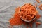 Fusilli red lentil pasta on a gray textile background