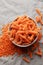 Fusilli red lentil pasta on a gray textile background