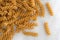 Fusilli whole wheat organic pasta on marble cutting board