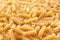 Fusilly Italian raw pasta backgroung. Angle view