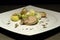 Fusion cuisine with potato, toasted bread,   salad, pate, truffle on a white dish