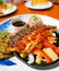 Fusion japanese food-mackerel fish steak soy sauce, Grilled fish with white sesame seed topping and vegetables side dish bell