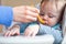 Fussy Baby Boy In High Chair Refusing Food At Meal Time