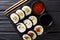 Futomaki rolls with various fillings are served with sauces close-up on a slate board. horizontal top view