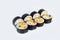 Futomaki Sushi Roll servwed on light background. Maki roll with unagi eel, mango, avocado, flying fish roe tobiko caviar and Phi