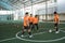 futsal players passing the ball with other players block it