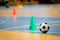 Futsal practice pitch. Indoor soccer ball and training equipment on the wooden floor