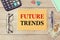 Future trends is written on a notepad, on an office desk with office accessories