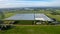 Futuristic Agriculture: Aerial View of Industrial Glasshouses Amidst Expansive Farm Fields