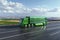 Futuristic autonomous green truck on a highway. Cargo delivery, transportation of the future