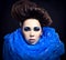 Futuristic beautiful young female face with blue fashion make-up.