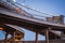 Futuristic bifurcation under the Brooklyn bridge in late sunset