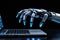 Futuristic cyborg robot arm glowing with blue LEDs, working at laptop, on blurred black background. AI robot typing on laptop