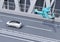 Futuristic flying car flying over a silver sedan driving on highway