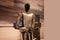 futuristic humanoid robot named Tesla Bot Optimus, designed by Tesla, stands in sleek, modern environment, showcasing advanced