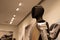 futuristic humanoid robot named Tesla Bot Optimus, designed by Tesla, stands in sleek, modern environment, showcasing advanced