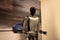 futuristic humanoid robot named Tesla Bot Optimus, designed by Tesla, stands in sleek, modern environment, showcasing advanced