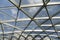 Futuristic metal and glass roof design close-up. Modern ceiling with elements of glass, metal mesh