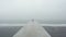 Futuristic Minimalism: A Captivating Image Of An Empty Dock In The Fog