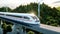 Futuristic, modern Maglev train passing on mono rail. Ecological future concept. Aerial nature view. 3d rendering.