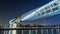 Futuristic Pedestrian Bridge over the Dubai Water Canal Illuminated at Night timelapse hyperlapse, UAE.