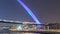 Futuristic Pedestrian Bridge over the Dubai Water Canal Illuminated at Night timelapse, UAE.