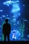 Futuristic picture, water aquarium glow sink silhouettes human glow of fish