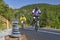 Futuristic Serenity: Blurred Cyclists Embarking on an Endless Journey Amidst Zen Stones