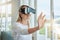 Futuristic woman with VR headset and digital ai with her hands. Young female with virtual reality goggles app, playing