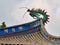 Fuzhou - A close up on the richly decorated rooftop of a temple in Fuzhou, China. There is a colorful head of the dragon