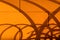 Fuzzy blurry curved shadow on the orange wall. Abstract shadow drawing on the wall in summer at the end day