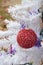 Fuzzy red glitter Christmas ornament hanging white Christmas tree