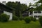 FÃ¼ssen, Germany 27 May 2019  - Cozy alpine houses with wooden roofs lost in green rainy valley among mountains. Little german