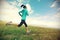 G fitness woman runner running on beautiful trail in grassland