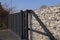 Gabion. Automatic entrance gate used in combination with a wall made of gabion