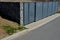 Gabion yard for placing containers for sorting household waste. gray door and halving of perforated metal grid, expanded metal. st