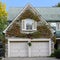 gable above garage doors with colorful ivy