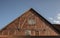 The gable of a half-timbered barn with brick facade