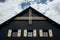 Gable roof of ancient cottage with cloudy sky