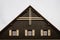 Gable roof of cottage with grey clouds in background