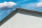 Gable roof, house roofing with sky in background