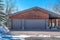 Gabled garage of home in Park City Utah with two gray doors at teh entrance