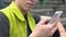 Gadget addicted young man scrolling social network on cellphone outdoor, app