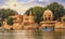 Gadi Sagar lake Gadisar Jaisalmer Rajasthan with ancient temple and archaeological ruins at sunset