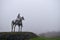 The Gaelic Chieftain Sculpture seen in the distance through the fog in County Roscommon in Ireland