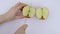 A gala apple is cut into four pieces on white cutting board.