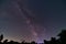 Galactic core of the Milky way galaxy with silhouetted leaves in the foreground