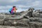 Galapagos tourist photographer taking photos Marine Iguanas on Fernandina Island