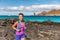 Galapagos tourist walking on Santiago Island in Galapagos Islands