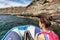 Galapagos tourist woman riding on panga zodiac boat tour in the Galapagos island